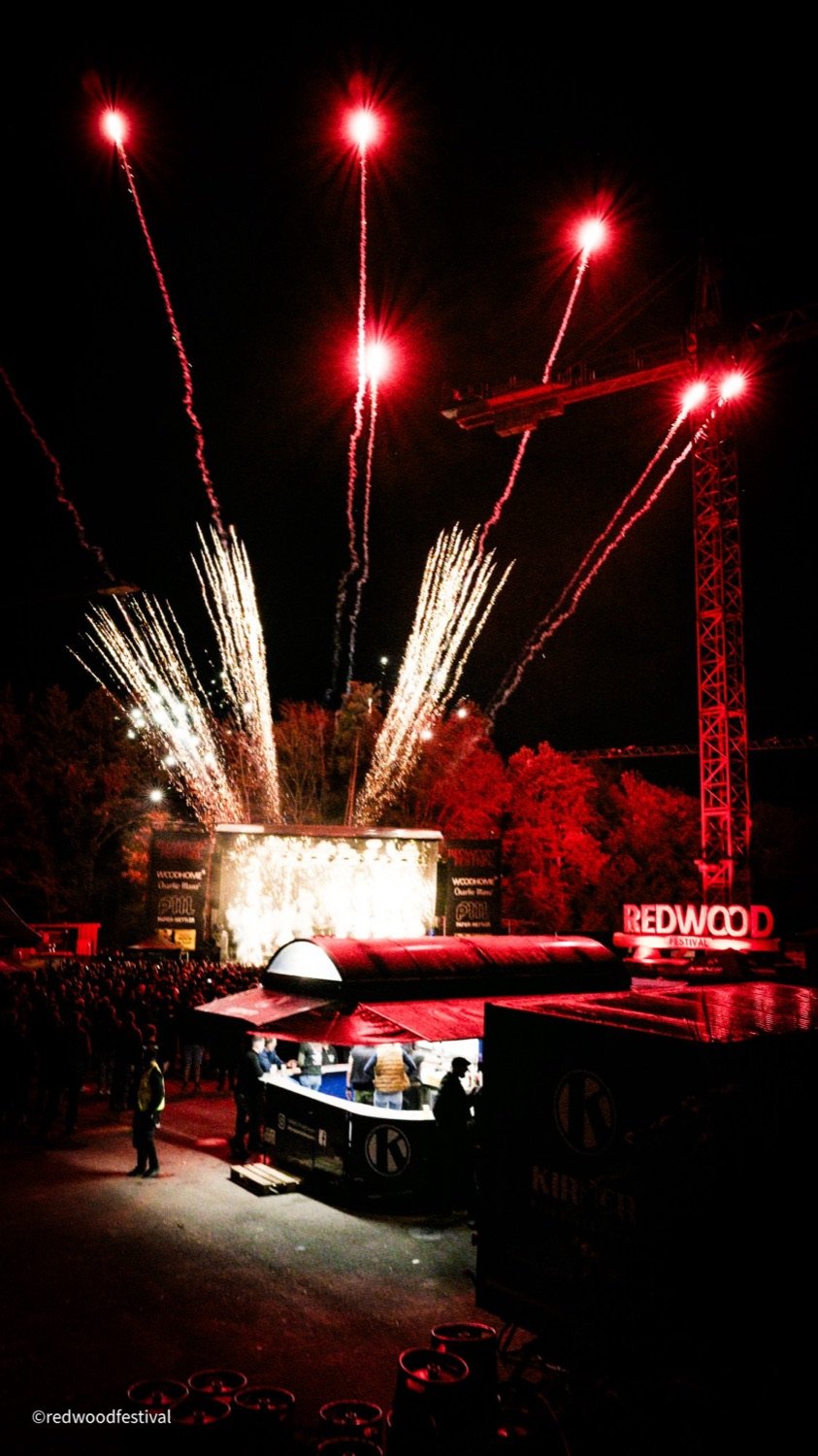 Feuerwerk über der Bühne bei Nacht, Baukran rot beleuchtet